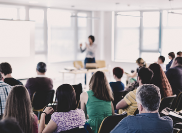 Speaker standing at the front of a classroom